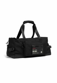 Sac de sport rectangulaire noir avec doubles poignées, poche zippée à l'avant, sangles latérales réglables et une étiquette avec des pictogrammes de soin et du texte.