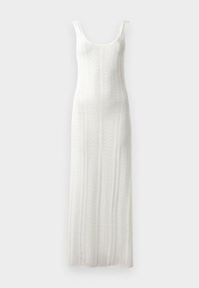Knit white maxi dress with a scoop neckline, ribbed texture, and wide straps. Features vertical stripe pattern and a straight silhouette.