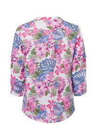 Floral blouse featuring a white background with pink, purple, and green tropical prints, long sleeves, and a relaxed fit.