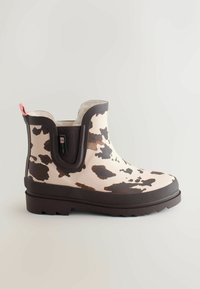 Brune og beige vandtætte ankelstøvler med ko-print, gummimateriale, tekstureret sål, elastiske sidepaneler og en pink hækvippel.
