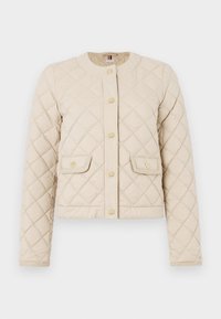 Beige quilted jacket with a round neckline, front pockets, and gold button closures. Features diamond pattern and textured detail on cuffs.