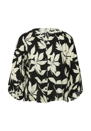 Blouse noire et blanche à manches longues avec grand imprimé floral, boutonnée sur le devant, encolure ronde et poignets froncés.