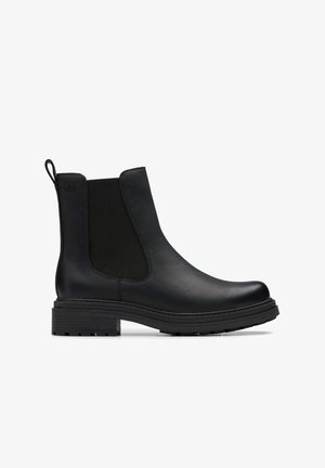 Schwarze Lederstiefel bis zum Knöchel mit elastischen Seitenteilen, runder Schuhspitze und strukturierten Gummisohlen. Mit einer Zuglasche auf der Rückseite.