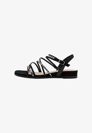 Zwarte platte sandalen met meerdere smalle bandjes met metallic accenten, een gladde zool en een verstelbare enkelgesp.