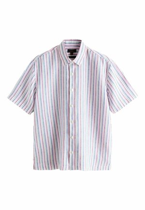 Ein Mann mittleren Alters mit einem salt-and-pepper Bart, der ein kurzärmeliges, geknöpftes Hemd mit vertikalen Pastellstreifen trägt und leicht wegschaut.