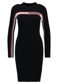 Abito nero a costine con maniche lunghe, scollo rotondo e righe orizzontali rosse e bianche sul petto con il logo "SUPERDRY".