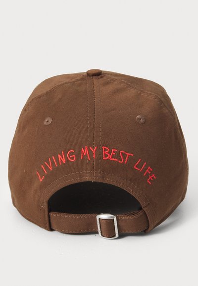 Brown cotton baseball cap featuring embroidered red text that reads "LIVING MY BEST LIFE" on the back and a silver adjustable buckle.