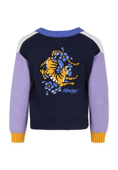 Pull marine avec des manches violettes, lavande et blanches. Il présente un tigre et des fleurs brodés, des poignets côtelés et un col rond.