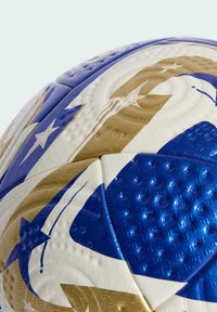 Soccer ball featuring a textured surface with blue, gold, and white colors, accented by star patterns and smooth, shiny sections.