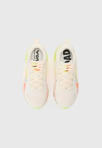 Sport sneakers with a breathable mesh upper in white, featuring neon yellow and coral accents. Light sole with textured pattern.