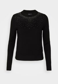 Maglione nero con maniche lunghe e polsini a coste. Presenta un gradiente di borchie argentate vicino al collo. Tessuto morbido e lavorato a maglia.