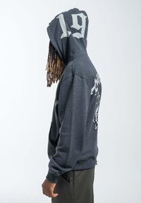 Dark gray hoodie with a large white "19" on the hood, graphic design on the back, and ribbed cuffs and hem. Smooth texture.
