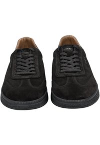 Black suede sneakers with a rubber sole, rounded toe, flat laces, stitching accents, and a smooth tan leather interior.