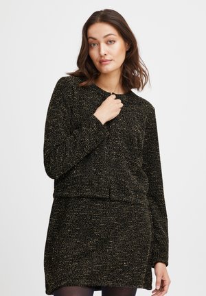 Vestito nero con una texture lavorata e un sottile motivo a glitter dorati, dotato di maniche lunghe e scollatura rotonda. Tessuto morbido e design aderente.