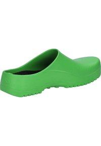 Sabots en caoutchouc verts avec surface texturée, dos ouvert et talon légèrement surélevé. Dispose d'une semelle robuste avec traction.