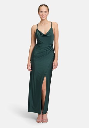 Long green evening dress made of smooth fabric, featuring a cowl neckline, slim fit, draped detail, and a thigh-high slit.