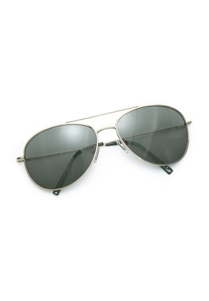 Aviator sunglasses with thin metallic frames and dark tinted lenses resting on a white surface.