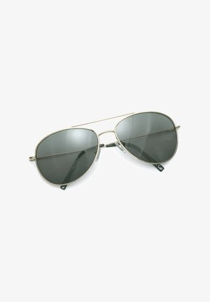 Aviator sunglasses with thin metallic frames and dark tinted lenses resting on a white surface.