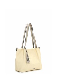 Tote bag van licht crèmekleurige stof met een slappe, nonchalante vorm. Voorzien van twee leren banden met zwarte accenten en een tassel detail.