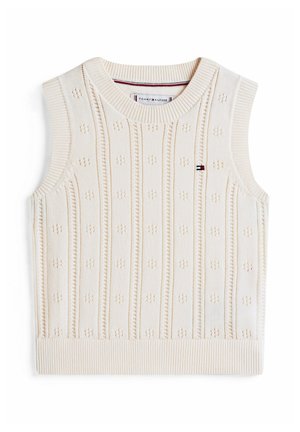 Pull en tricot crème sans manches avec un motif texturé et des bords côtelés. Comprend des lignes horizontales et de petits points décoratifs sur toute sa surface.
