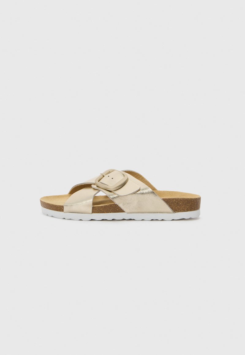 Slide sandal in metallic gold faux leather with a wide adjustable strap, cork footbed, and white rubber sole featuring a textured pattern.