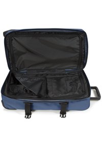 Rolling suitcase with a blue exterior, open to reveal a black interior. Features multiple compartments and sturdy zippers.