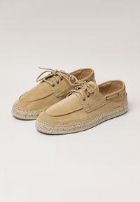 Wildleder-Tan-Schuhe mit runder Spitze, Schnürdesign und gewebter Jutesohle. Verfügt über Metallösen und gestickte Details im Obermaterial.