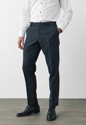 Dark grey formal trousers made of textured fabric, with a flat front and two side pockets, paired with black leather shoes.