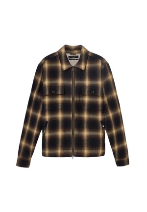 Schwarze und braune karierte Zip-Jacke mit Kragen, zwei Fronttaschen und glatter Stofftextur. Mit Knopfakzenten auf den Taschen.