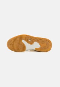 Shoe sole with a gum rubber outsole and white midsole. Features traction patterns and a logo in the center. Curved design and textured surface.