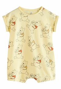 Une salopette jaune avec un imprimé intégral d'un personnage d'ours tenant une fleur, à manches courtes, avec un col rond et une fermeture à pression à l'épaule.