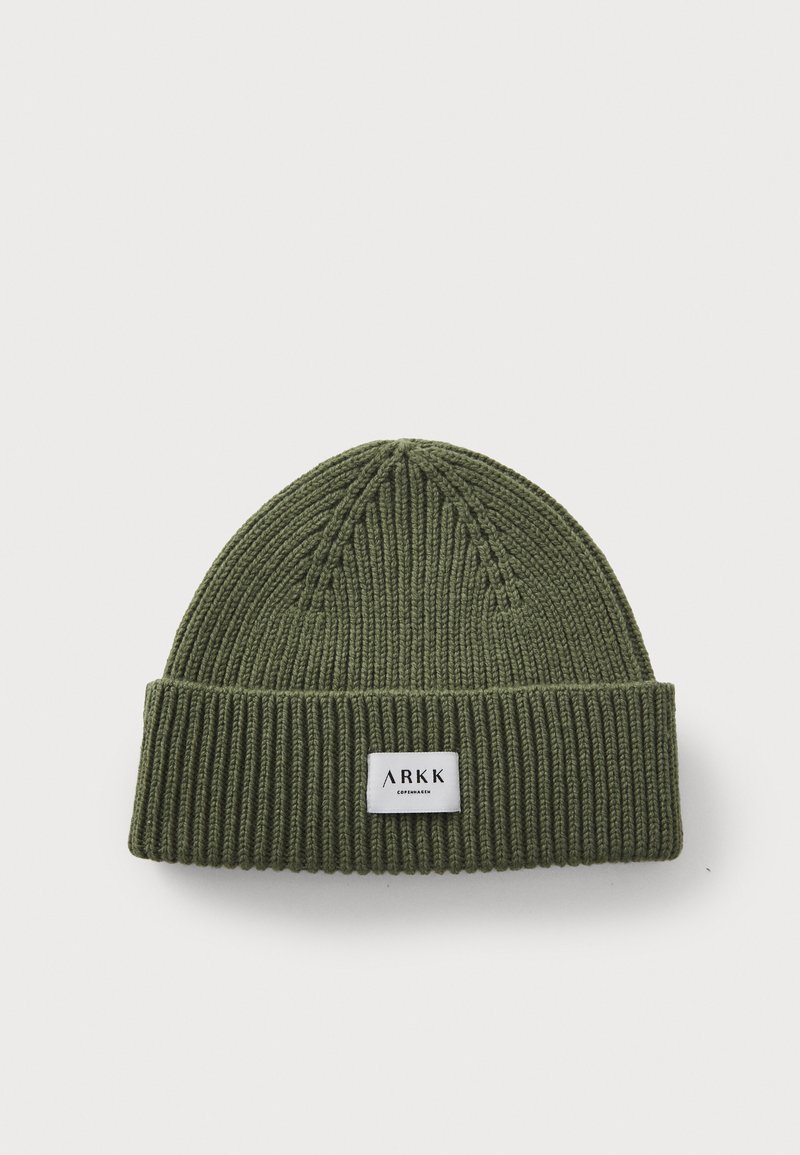 Dark green knitted beanie with a folded ribbed cuff. Features a small white label with "ARKK" branding stitched on the front.