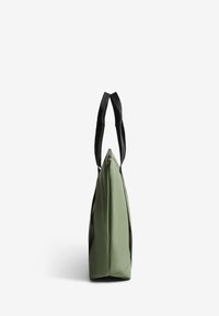 Green tote bag featuring a sleek design, made of smooth material with a contrasting black handle, flat shape, and no visible hardware.
