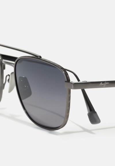 Sunglasses with a black metal frame, gray gradient lenses, herringbone pattern along the frame edge, and sleek black temple arms.
