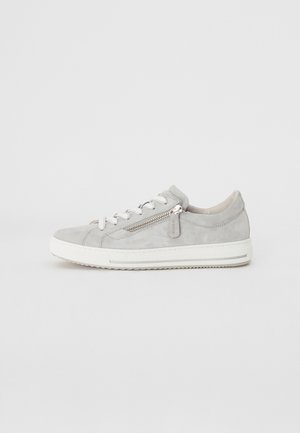 Baskets en suède gris clair avec semelle en caoutchouc blanc, lacets et une fermeture éclair décorative sur le côté. Elles comportent un bout arrondi et des éléments de design minimalistes.