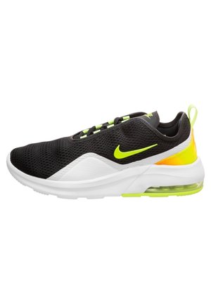 Czarno-białe sneakersy Nike z neonowo-żółtymi akcentami, siateczkową cholewką, widoczną podeszwą z poduszką powietrzną i pętelką na pięcie.