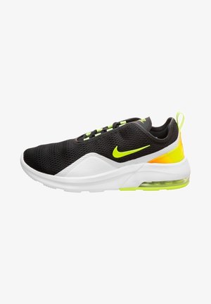 Czarno-białe sneakersy Nike z neonowo-żółtymi akcentami, siateczkową cholewką, widoczną podeszwą z poduszką powietrzną i pętelką na pięcie.