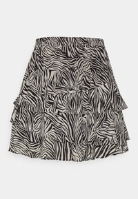 Jupe à imprimé zèbre noir et beige avec une conception à volants à niveaux, taille élastique et tissu léger.