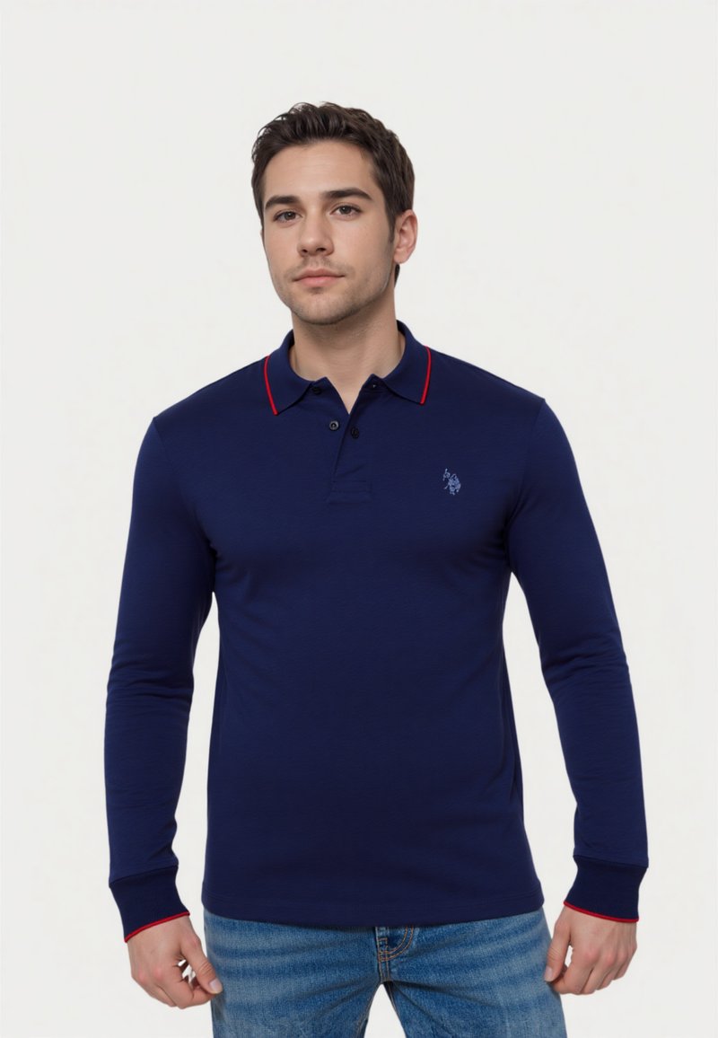 Navy blue long-sleeve polo shirt with red collar accents, three-button placket, and logo detail on the left chest. Cotton fabric.
