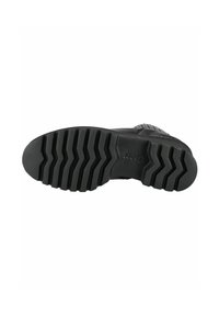 Black rubber shoe sole featuring a zigzag tread pattern, with a smooth texture and a brand logo embossed on the surface.