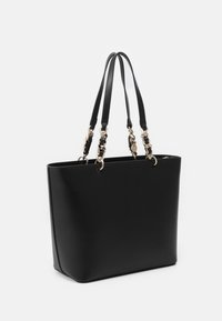 Black tote bag made of smooth synthetic material, featuring two top handles and gold-tone chain accents. Rectangular shape with structured base.