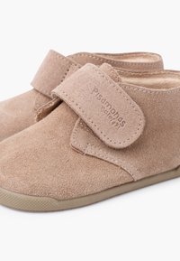 Beige suede toddler shoes with hook-and-loop strap closures and flexible rubber soles, designed for easy wear and comfort.