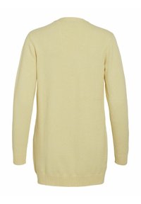 Ljusgul långärmad kofta; mjuk stickad struktur; ribbade mudd och fåll; längre baksida design; enkla, rena linjer utan utsmyckningar.