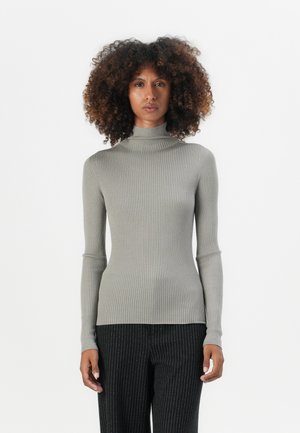 Gray ribbed turtleneck sweater with long sleeves, form-fitting design, soft texture, paired with pinstriped pants.