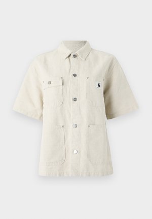 Short-sleeve shirt in light beige fabric, featuring a pointed collar, front buttons, two chest pockets, and a small logo patch on the left.