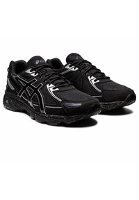 Pantofi sport negri cu partea superioară din plasă, accente argintii și o talpă texturată. Au un design cu șireturi și vârf întărit.