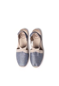 Blue and beige espadrilles with textured fabric, closed toe, elasticized straps, and a wavy edge on the beige trim.