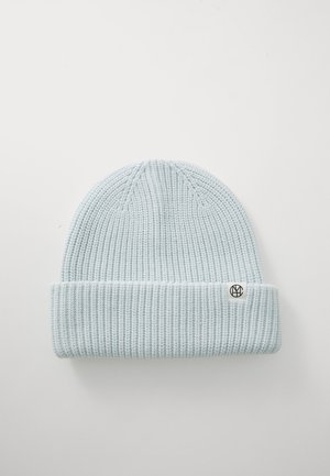 Light blue knitted beanie with a ribbed texture and cuff. Features a small black logo tag on the side. Soft fabric and snug fit.