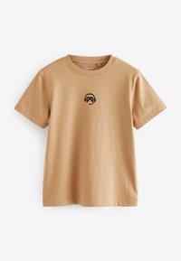 Beige Baumwoll-T-Shirt mit einem kleinen schwarzen Grafik eines Gaming-Headsets und Controllers auf der Brust. Rundhalsausschnitt und kurze Ärmel.