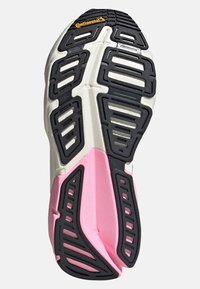 Semelle de chaussure avec motifs en caoutchouc noir, accents blancs et roses. Comprend des sections profilées pour l'adhérence, marquées du logo Continental.